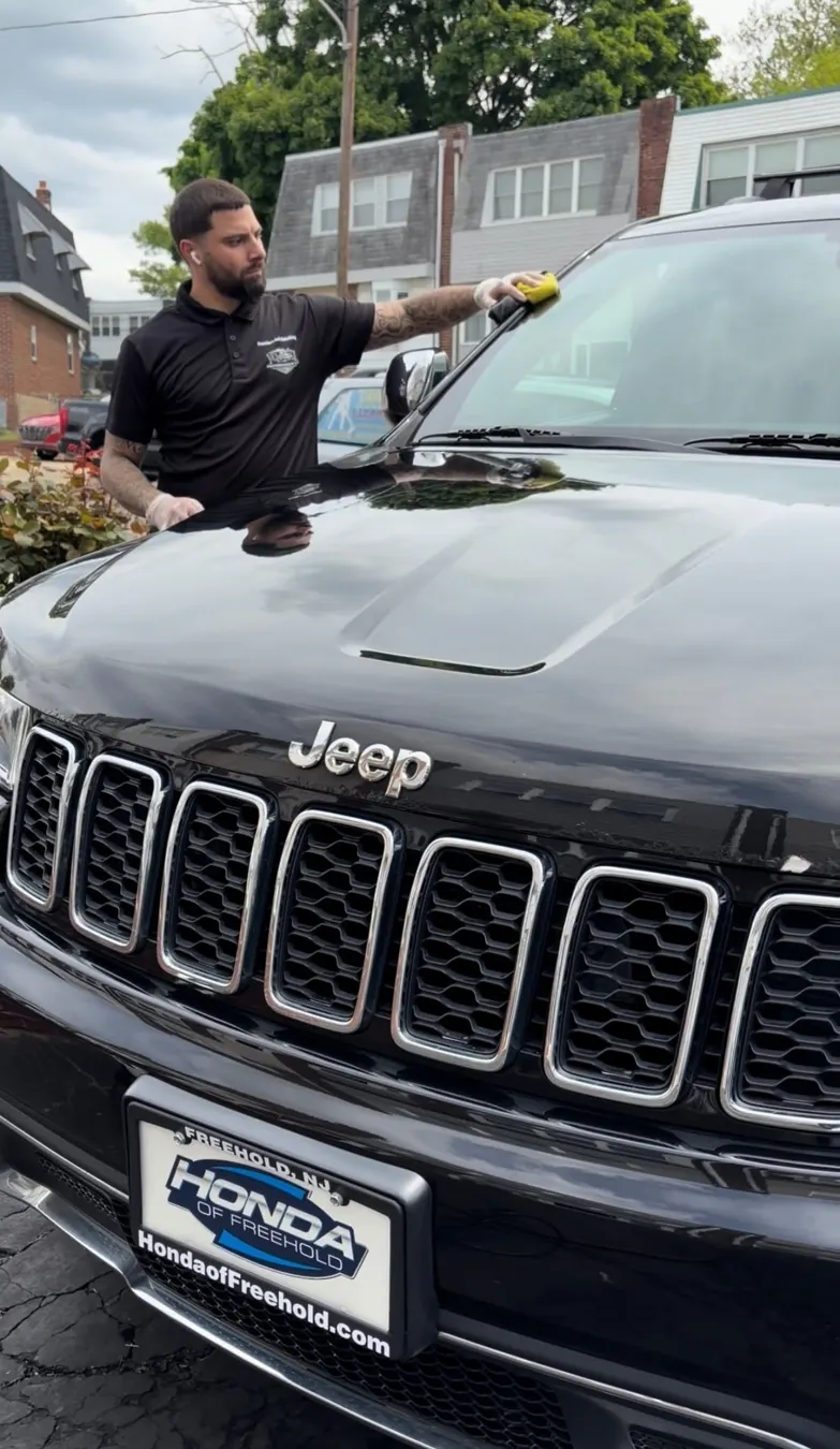 Polishing the hood of a black Jeep